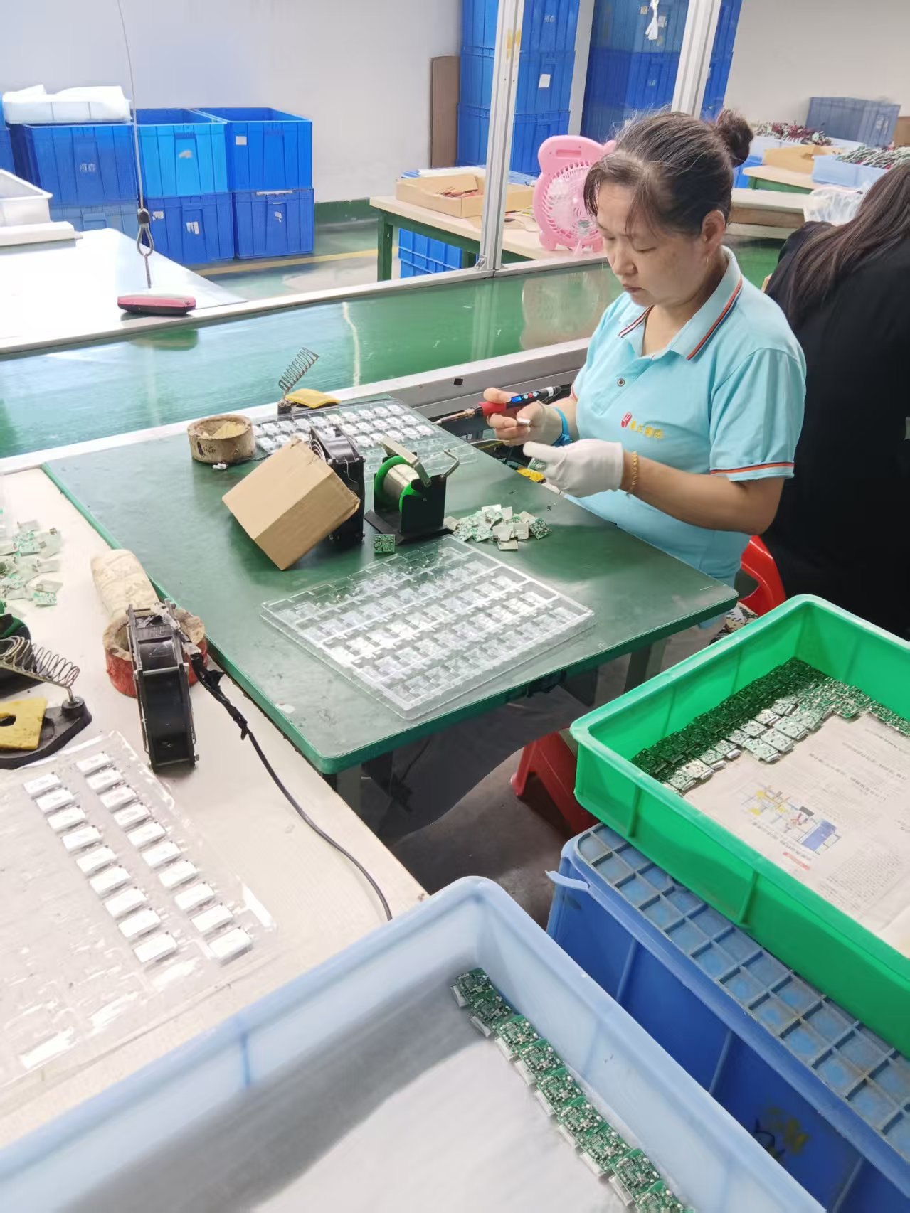 Worker assembling LED modules in the YH Lighting factory